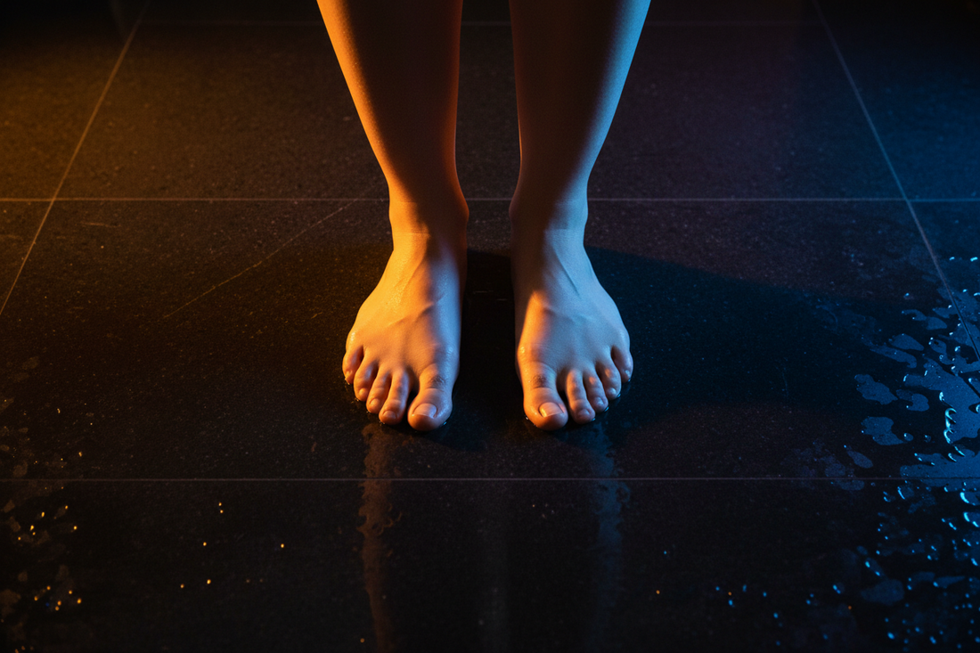 Top view of bare feet with dramatic lighting symbolizing foot health warning signs